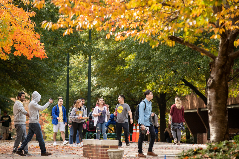 Students walking the Fairfax Campus with fall colors.